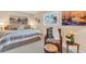This cozy bedroom features nautical-themed decor, soft lighting, and a comfortable sitting area at 5349 Everwood Run, Sarasota, FL 34235