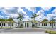 Welcoming front exterior of the community clubhouse, framed by beautiful palm trees and manicured landscaping at 5349 Everwood Run, Sarasota, FL 34235