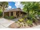 Charming clubhouse with wood siding, surrounded by lush landscaping, offering a welcoming community gathering space at 5349 Everwood Run, Sarasota, FL 34235