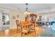 Bright dining area with views into the living area and featuring a wooden table and chairs under a decorative light fixture at 5349 Everwood Run, Sarasota, FL 34235