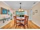 Charming dining room with a round wood table, four chairs, and a view of the backyard creates a perfect spot for meals at 5349 Everwood Run, Sarasota, FL 34235