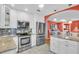 Stylish kitchen with white cabinets, granite countertops, stainless steel appliances, and modern backsplash at 5349 Everwood Run, Sarasota, FL 34235