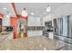 Well-appointed kitchen featuring white cabinetry, stainless steel appliances, mosaic backsplash, and granite countertops at 5349 Everwood Run, Sarasota, FL 34235