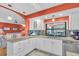 Bright kitchen with white cabinets, granite counters, stainless steel appliances, and a view to the living area at 5349 Everwood Run, Sarasota, FL 34235