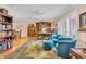 Spacious living room with hardwood floors, a comfortable seating area, and built-in bookshelves provides a versatile living space at 5349 Everwood Run, Sarasota, FL 34235