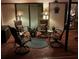 Cozy outdoor patio with comfortable seating, stylish lamps, and lush plants for serene relaxation and gatherings at 5349 Everwood Run, Sarasota, FL 34235