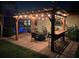 Pergola featuring backyard entertaining area with patio at night and string lights at 5349 Everwood Run, Sarasota, FL 34235