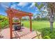 Outdoor pergola with bar seating and exterior dining on a brick paver patio at 5349 Everwood Run, Sarasota, FL 34235