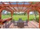 Exterior dining area in backyard featuring a pergola with bar seating, with a view of the backyard at 5349 Everwood Run, Sarasota, FL 34235