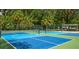 Well-maintained pickleball courts with vibrant blue and green surfaces, surrounded by lush greenery, offer recreational opportunities at 5349 Everwood Run, Sarasota, FL 34235
