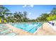 A refreshing pool with lane markers surrounded by comfortable lounge chairs and lush greenery at 5349 Everwood Run, Sarasota, FL 34235