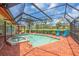 Backyard pool area with enclosed pool and hot tub, and poolside furniture at 5349 Everwood Run, Sarasota, FL 34235