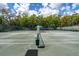 Well-maintained tennis courts with green surfaces, complete with nets and lighting, provide an excellent recreation space at 5349 Everwood Run, Sarasota, FL 34235