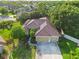 Beautiful home features a tile roof, lush landscaping, and an attached two-car garage at 5401 Oak Grove Ct, Sarasota, FL 34233