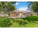 Large backyard showing the patio, a screened-in porch, and a well-kept lawn at 5401 Oak Grove Ct, Sarasota, FL 34233