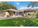 Well-maintained backyard features a screened lanai, patio area, and a generous lawn at 5401 Oak Grove Ct, Sarasota, FL 34233