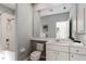 Bathroom with a large mirror, white vanity, and tub/shower combination, offering a clean and functional space at 5401 Oak Grove Ct, Sarasota, FL 34233
