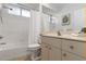 Bright bathroom features a shower-tub combo with white tile surround and modern vanity at 5401 Oak Grove Ct, Sarasota, FL 34233
