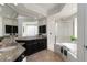 Bright bathroom with double sink vanity, granite countertops, a separate tub, and glass-enclosed shower at 5401 Oak Grove Ct, Sarasota, FL 34233