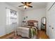 Cozy bedroom features a plush bed, wood floors, and abundant natural light at 5401 Oak Grove Ct, Sarasota, FL 34233