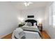 Cozy bedroom featuring a comfortable bed, a 'good night sleep tight' sign, and a view of nature at 5401 Oak Grove Ct, Sarasota, FL 34233