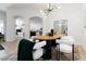 Bright dining room featuring a modern light fixture and decor with an archway to the kitchen at 5401 Oak Grove Ct, Sarasota, FL 34233