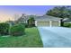 Charming single-story home with a two-car garage, lush front yard, and well-maintained landscaping at 5401 Oak Grove Ct, Sarasota, FL 34233
