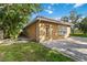 Home exterior with paved side yard, well-maintained lawn, and manicured landscaping at 5401 Oak Grove Ct, Sarasota, FL 34233