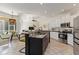 Bright open-concept kitchen boasts an island with seating, stone countertops and lots of natural light at 5401 Oak Grove Ct, Sarasota, FL 34233