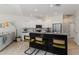 Modern kitchen featuring a large island with seating, stainless steel appliances, and white cabinets at 5401 Oak Grove Ct, Sarasota, FL 34233