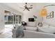 Bright living room featuring tile flooring, a ceiling fan, vaulted ceilings, and sliding glass doors for natural light at 5401 Oak Grove Ct, Sarasota, FL 34233
