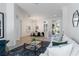 Elegant living room showcasing stylish furniture and seamless flow to dining area and patio at 5401 Oak Grove Ct, Sarasota, FL 34233