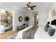 Bright main bedroom featuring a ceiling fan, sliding glass door, and a seating area at 5401 Oak Grove Ct, Sarasota, FL 34233