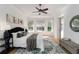 Sunlit main bedroom with bay window, ceiling fan, stylish rug, and a sliding glass door at 5401 Oak Grove Ct, Sarasota, FL 34233