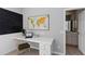 Bright home office with a large world map, white desk, and view into the bathroom providing a functional workspace at 5401 Oak Grove Ct, Sarasota, FL 34233