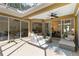 Outdoor patio featuring comfortable seating, a ceiling fan, and views of the living room, kitchen, and dining area at 5401 Oak Grove Ct, Sarasota, FL 34233