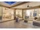 Covered patio with ample seating, a ceiling fan, and views of the living room, kitchen, and dining area at 5401 Oak Grove Ct, Sarasota, FL 34233