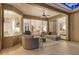 Cozy sunroom with ample seating, a ceiling fan, and sliding glass doors leading to the house at 5401 Oak Grove Ct, Sarasota, FL 34233