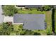 Birds eye view of a home with a screen lanai, mature trees, and lush landscaping at 5508 Whitehead St, Bradenton, FL 34203