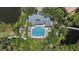 Top-down aerial view of the pool and outdoor spa surrounded by trees and lounge seating at 5508 Whitehead St, Bradenton, FL 34203