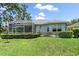 The backyard features a screen lanai and lush landscaping at 5508 Whitehead St, Bradenton, FL 34203