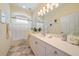 Bright bathroom features a single sink vanity with neutral countertop and a shower-tub combo at 5508 Whitehead St, Bradenton, FL 34203