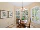 Charming dining area with white shutters, wood table, and decor, filled with natural light at 5508 Whitehead St, Bradenton, FL 34203