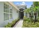 Beautiful home exterior showcasing lush landscaping, and a charming entrance with a dark front door at 5508 Whitehead St, Bradenton, FL 34203