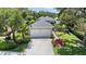 Charming home featuring a well-manicured lawn, vibrant landscaping, and a two-car garage at 5508 Whitehead St, Bradenton, FL 34203