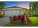 Charming home featuring a well-manicured lawn, vibrant landscaping, and a two-car garage at 5508 Whitehead St, Bradenton, FL 34203