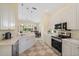 Well-equipped kitchen with stainless steel appliances, quartz countertops, and views into the dining room at 5508 Whitehead St, Bradenton, FL 34203