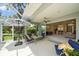Covered lanai offers an outdoor living space with seating and views of the landscaped backyard at 5508 Whitehead St, Bradenton, FL 34203