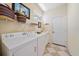 Bright laundry room features front loading washer and dryer and a utility sink at 5508 Whitehead St, Bradenton, FL 34203
