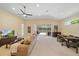 Spacious living room with high ceilings, neutral tones, and sliding glass doors to a screened lanai at 5508 Whitehead St, Bradenton, FL 34203